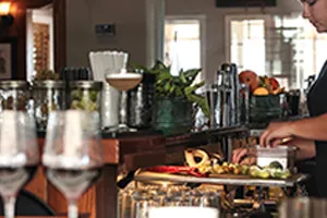 Bartender slicing limes behind bar