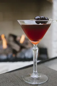 Bitters berry martini garnished with fruit