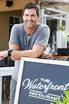 employee appreciation Owner Jason Suzor in Front of Sidewalk sign