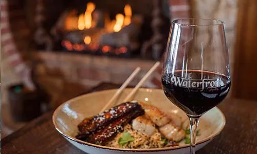 Red Wine Glass with Scallops in Background
