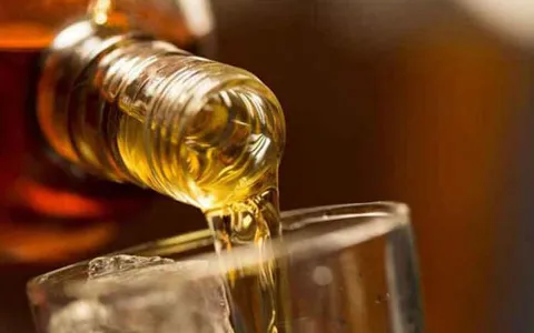 Whiskey being poured in tumbler