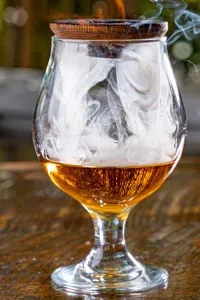Whiskey in a snifter with smoke